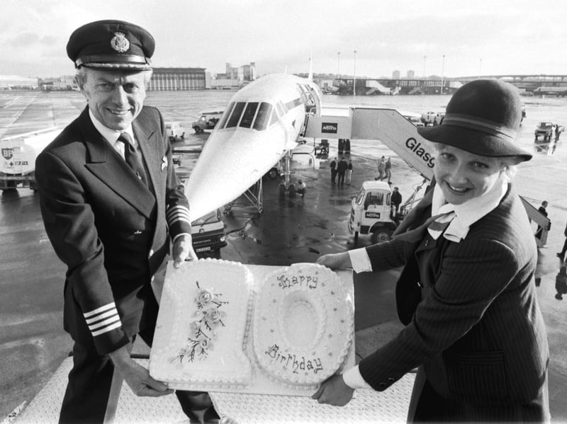 Captain John Burton and British Airways steward Scarlett Green celebrate the 10th birthday of the company's Concorde with a birthday cake at Glasgow Airport in January 1986