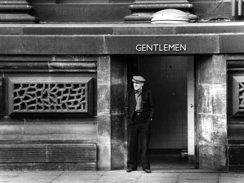 The rear of the Town Hall in St. George Street where the Gentlemens' public toilets are located. An elderly man in flat cap stands in the doorway.