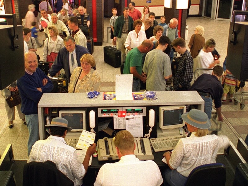 Holidaymakers check-in for a flight to Palma in June 1996.