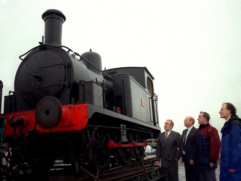 November 1998 and the Hunslet engine arrives back home 100 years later. Pictured,  from left, are Bob Cook, works manager and Mike Pearce, project  manager at Merlin Gerin Medium Voltage, Hunslet who occupy the site where the engine was built, and Ken Griffiths and Nigel Cripps of the Warwickshire Industrial Locomotive Preservation Group who own the engine.