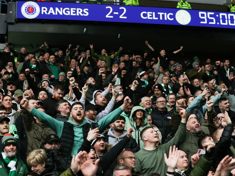 Celtic fans celebrate their injury-time equaliser at Ibrox.