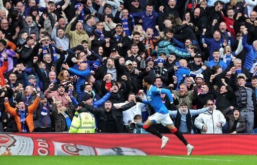 Rangers fans celebrate Youssef Chermiti's second goal against Celtic at Ibrox.