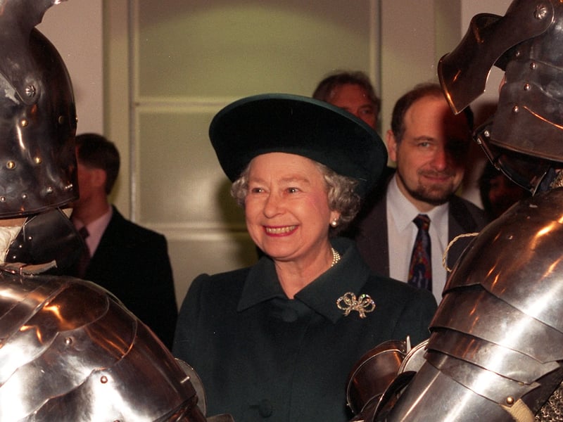 The Queen talks to two re enactors at the opening of the Royal Armouries in March 1996.