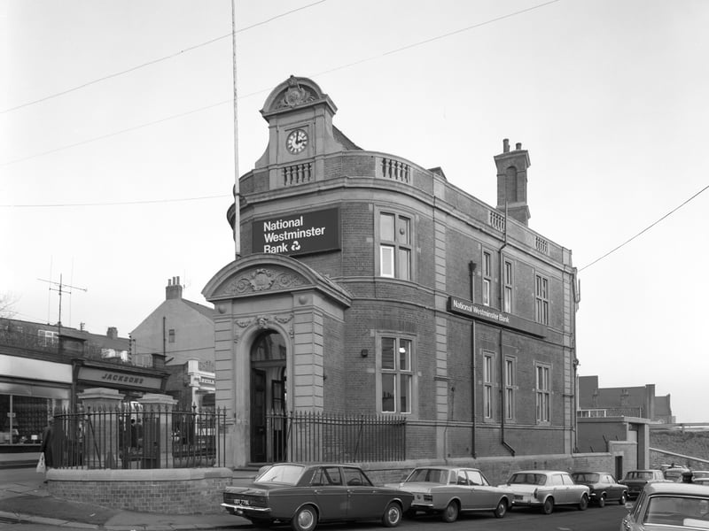 The distinctive NatWest Bank building in Mexborough, South Yorkshire, in 1971. The cars parked outside include a Hillman Minx, a Mk 2 Ford Cortina and a Mk 1 Ford Escort.
