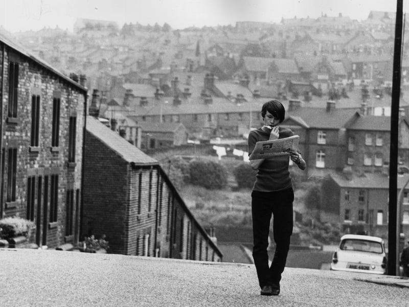 16-year-old David Bradley, star of the film 'Kes', wanders the streets of his hometown, Barnsley, whilst sucking on a lollipop and reading a newspaper, in August 1970