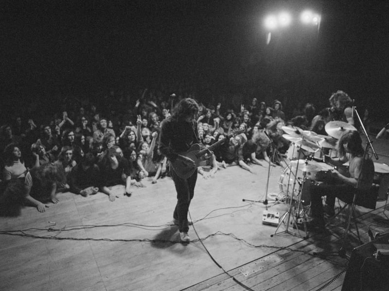 Irish singer and guitarist Rory Gallagher performs live on stage with bassist Gerry McAvoy and drummer Wilgar Campbell at Leeds City Hall in March 1972