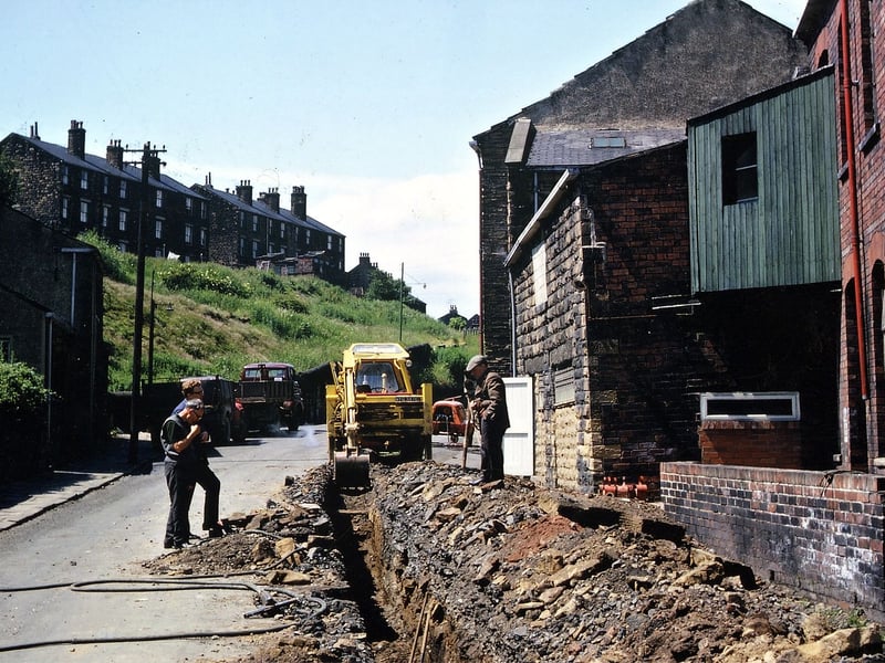 This trench, being dug by the gas board along Station Road in June 1967, uncovered an old well straight in front of the boiler house which had been joined on to the gable end of the fly wheel wall in the lithograph of Crank Mill in 1866.