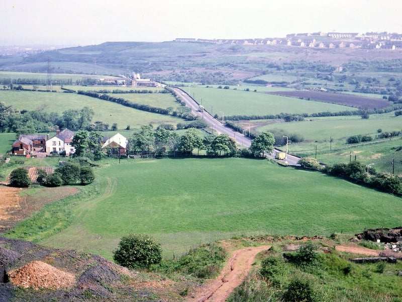 A view of the A653T Leeds to Dewsbury Road between Tingley roundabout and the junction with Wide Lane. The photograph was taken from the northern edge of Topcliffe Colliery spoil heap, which had mostly turned to red shale through continuous burning underground. Pictured in May 1967.