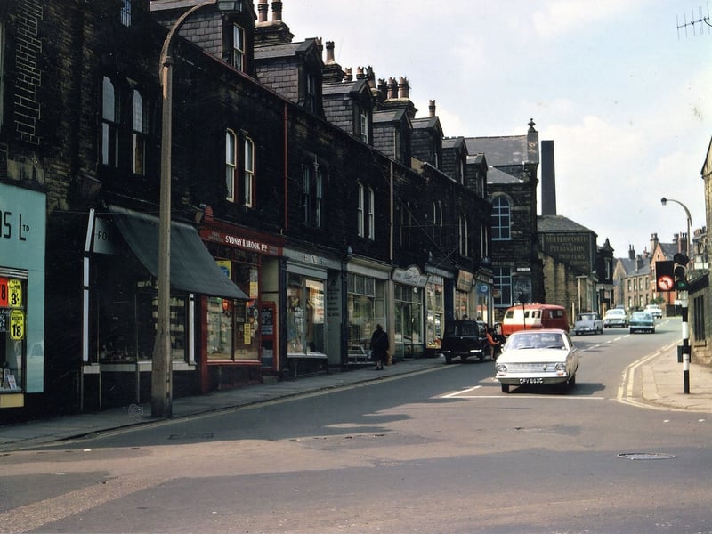 A parade of traditional small shops at the bottom of Fountain Street in July 1967. Among this parade are a grocer (Gallons), a pork butcher (Greens), a coal merchant (Sydney & Brook), a clothing shop, a baker's shop (Colbecks), a butchers, a greengrocers and a bicycle shop. The photo dates from about the time Asda had bought the empty Ebenezer Primitive Methodist Chapel, which was opposite the Temperance Hall at the other side of King Street where this parade of shops ends.