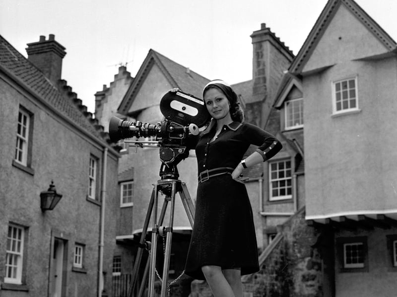Joanna Lumley with a film camera in White Horse Close, Edinburgh, while making a film for Scottish Cashmere in October 1972