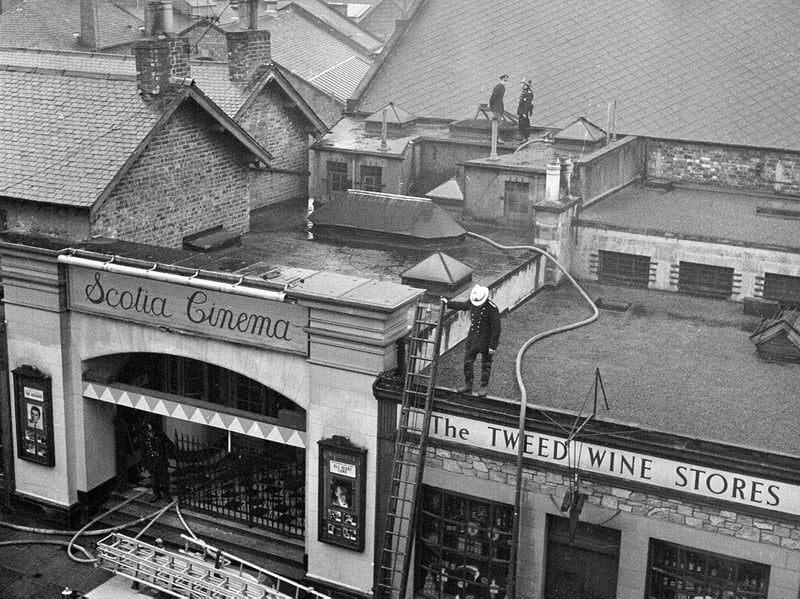 A fire at the Scotia Cinema in 1962, with a firefighters on the roof