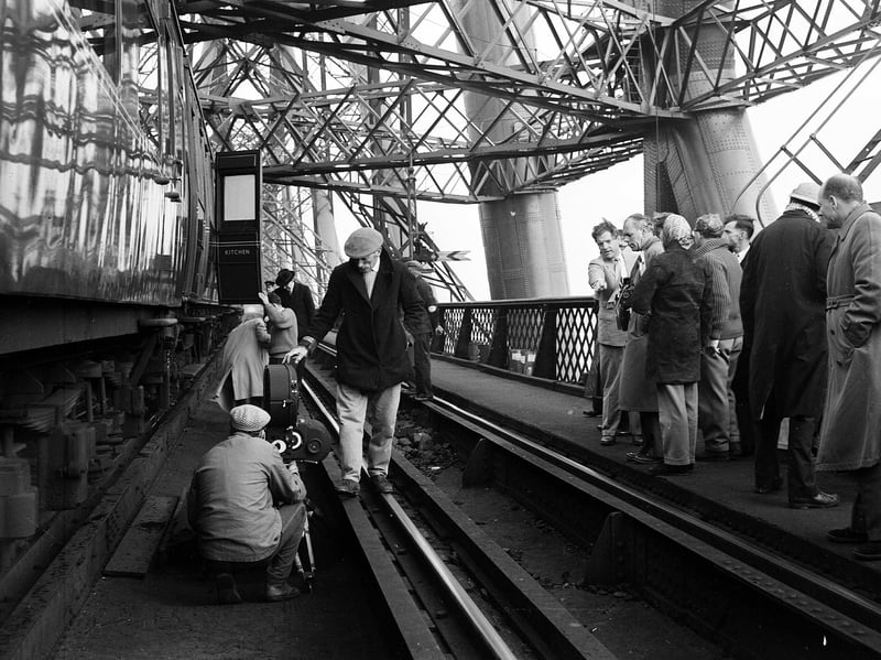 Filming the Forth Bridge scenes for the 1959 version of the film The 39 Steps, with actor Kenneth More to the right, pointing, in September 1958
