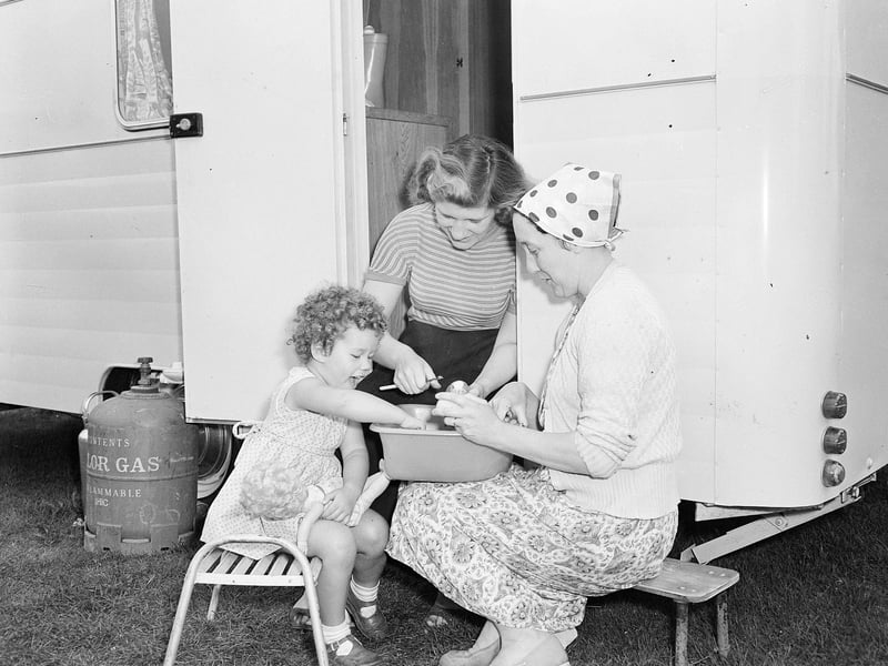 Mrs Snary, Mrs Mayer and little Margaret prepare lunch at the caravan site at Muirhouse in July 1957.