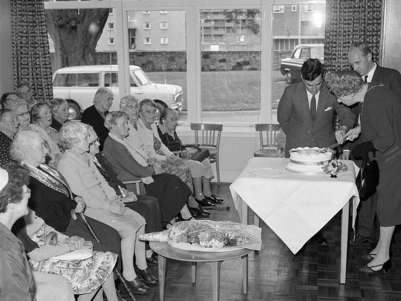 Lady Governor Mrs M Weatherstone cutsa cake presented to Silverlea Old Person's home in Muirhouse Parkway in September 1963.