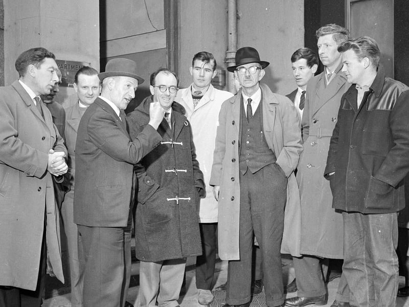 Union stewards talk to workers and official during a builders' strike at Muirhouse in November 1962.
