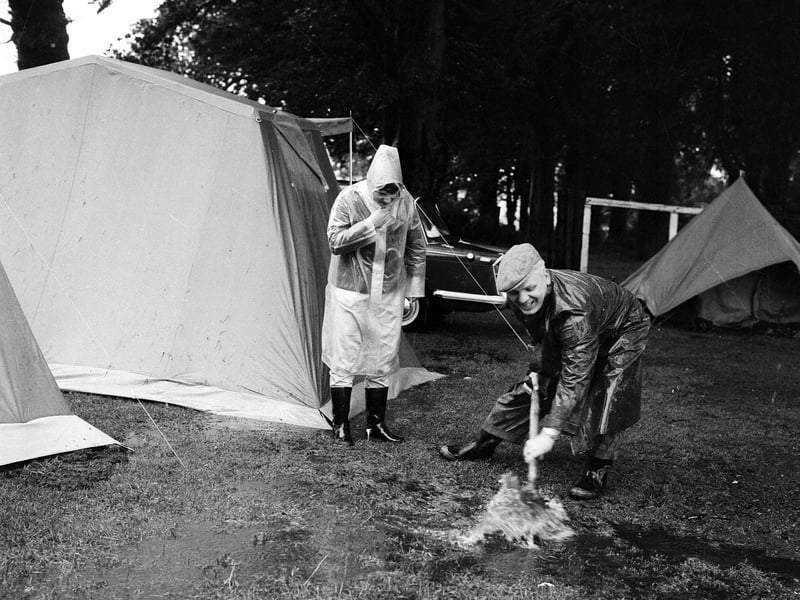 Clearing up after heavy rain caused flooding at Muirhouse caravan site in July 1965.