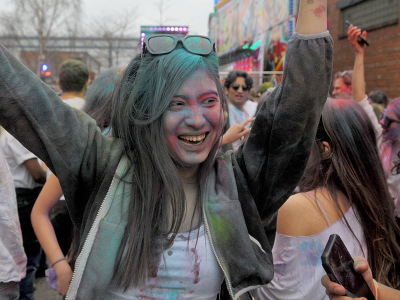 The annual celebration has become a major cross-cultural event, bringing together thousands of people for a day of music, dancing, and, of course, plenty of neon powder.