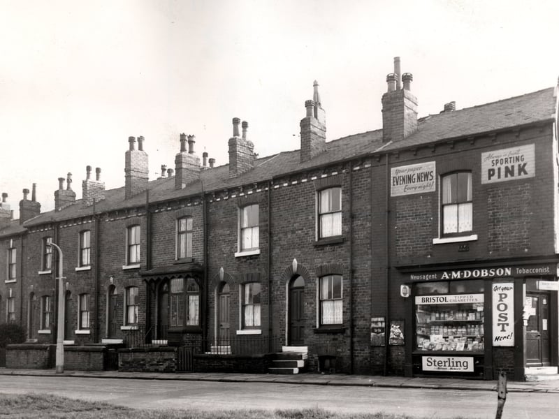 Red brick terraced houses in Hunslet Hall Road as it joins Moorville Road in November 1965. Numbers descend from 15 on the left to 3 on the right. Garden plots gradually increase in size as house numbers ascend. The corner shop is A.M. Dobson, newsagent and tobacconist and the window is lined with glass jars of sweets. Dobson's is number 1 Lady Pit Lane (far right)