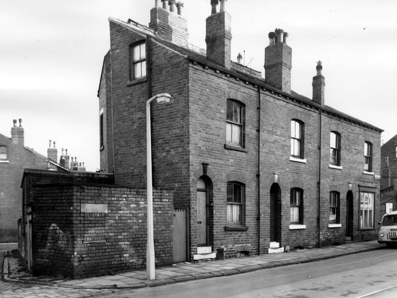 Terraced properties in Lady Pit Lane, numbering from left to right, 17 to 23. Toilets are located to the left of number 17 and the old midden opening in the wall has been bricked up. Pictured in November 1965.