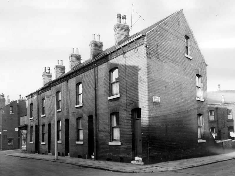 Through terraced properties occupying a triangular plot of land bordered by Disraeli Terrace and Freestone Place can be seen far right at the rear and part of Northcote Road can be seen far left. Pictured in November 1965.