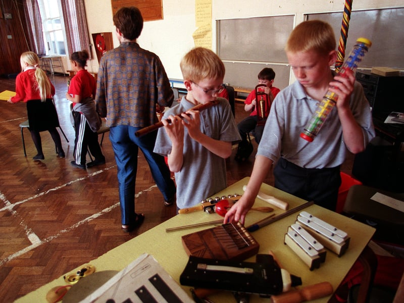 Community musician Gill Pearson takes a class at Clapgate Primary School in April 1999. Pictured choosing their instruments are Dale Emmerson, left, and David Ward.