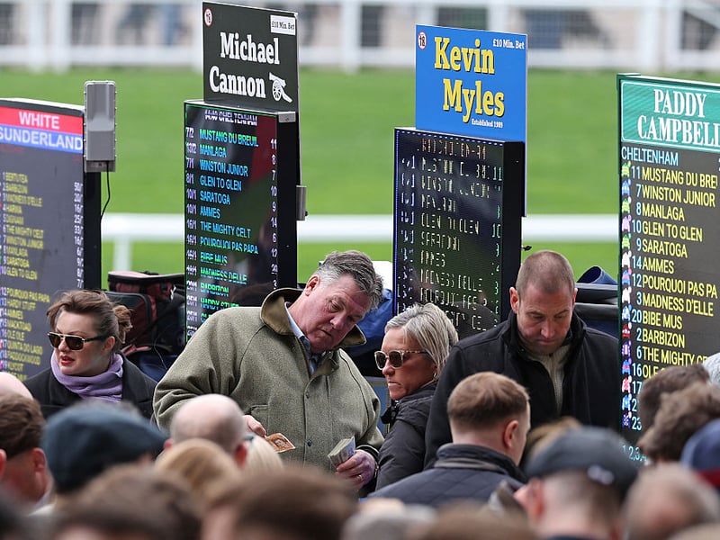 Bookmakers take bets on the first day of the Cheltenham Festival.