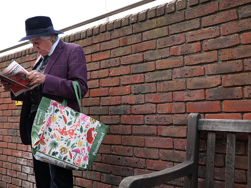 A raegoer checks the racecard.