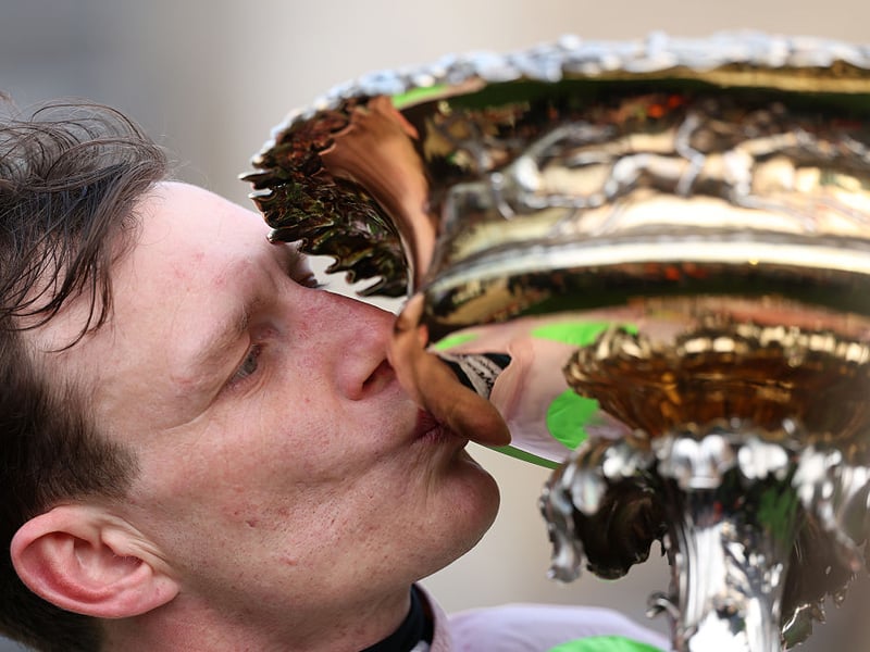 Paul Townend kisses the Champion Hurdle Challenge Trophy.