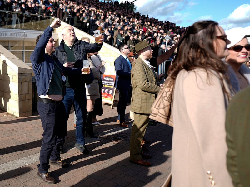 Cheering on the horses with a beer at Cheltenham.