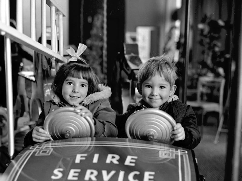 Children enjoy the funfair roundabout inside Goldbergs department store, Edinburgh, in November 1968