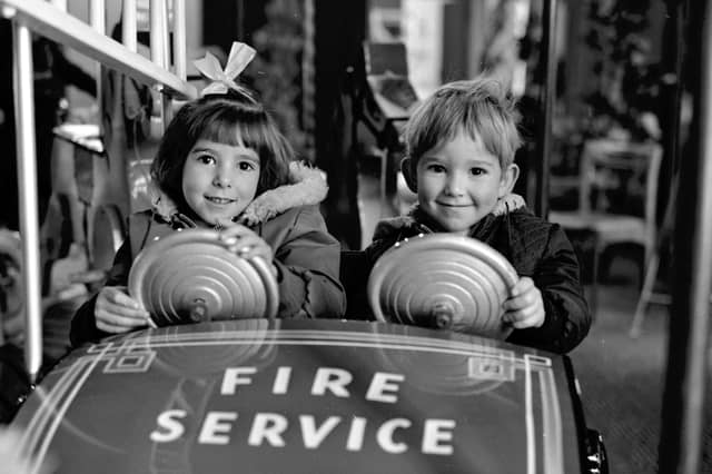 Children enjoy the funfair roundabout inside Goldbergs department store, Edinburgh, in November 1968
