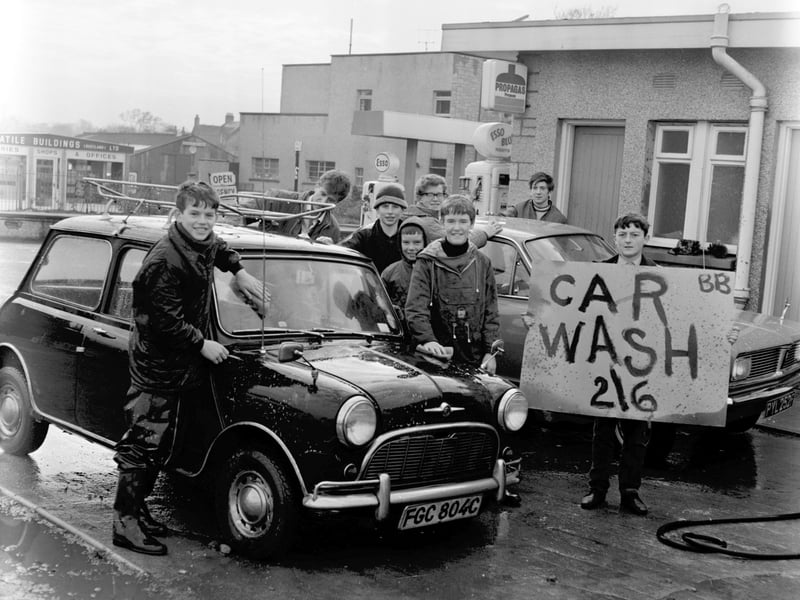 Members of Larbert Boys Brigade raise money by washing cars for 2/6 in November 1968