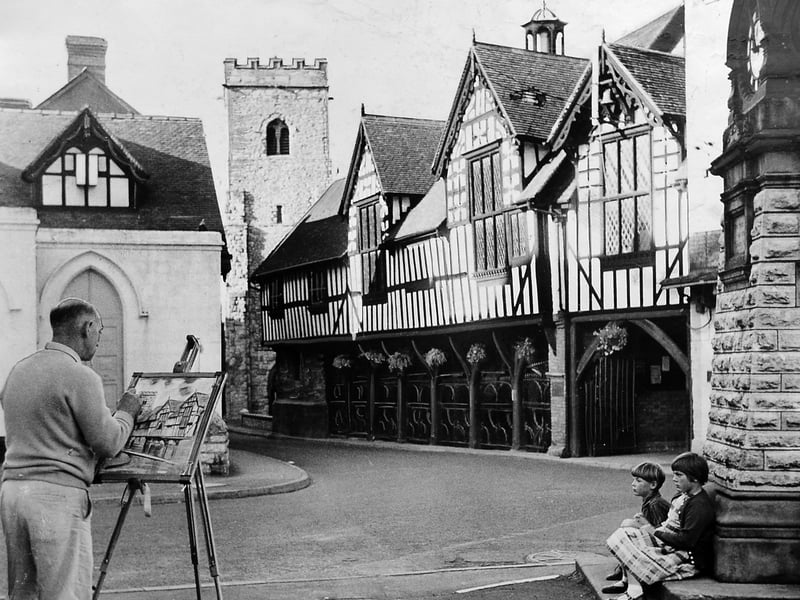 September 1962: In the long shadows of the late afternoon sun, artist Mr W H C Twist, of Newport, paints by the Old Butter Cross in the village centre at Much Wenlock.