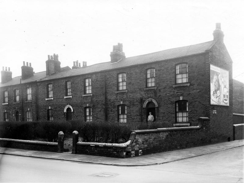 Burley Road in December 1959. A man is in the doorway of 179, this is the junction with Wordsworth Street. 