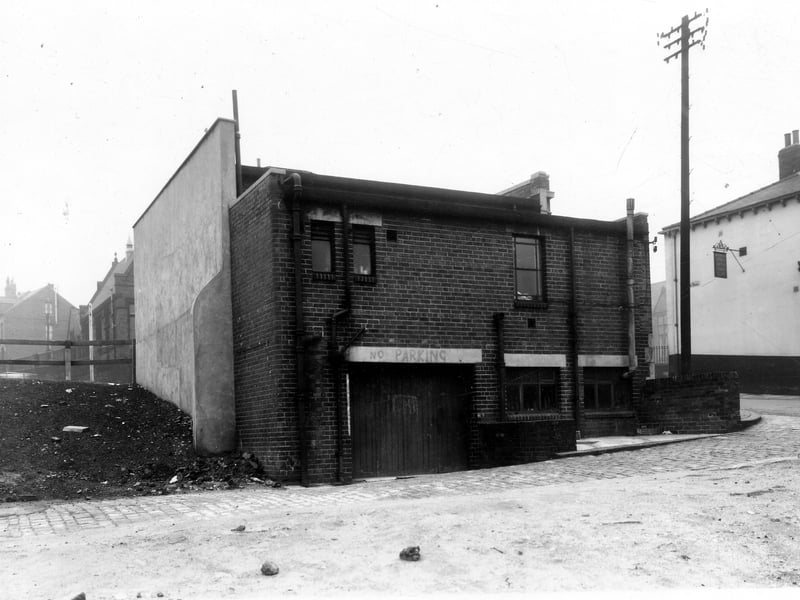 This is the rear view of number 231 Burley Road, a branch of the Leeds Skyrack and Morley Bank. On the right is Willow Road, the Burley Hotel public house can be seen. Pictured in December 1959.