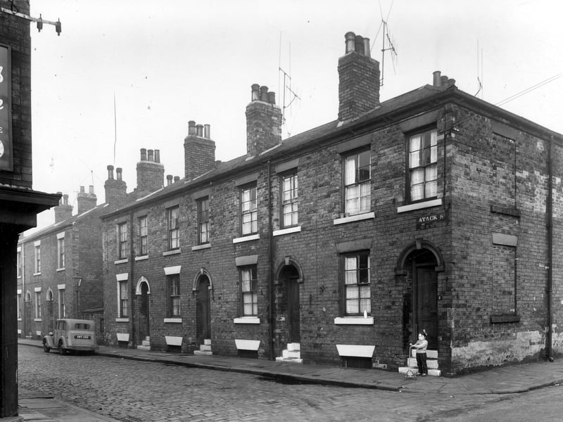 A section of Atack Street seen from Wordsworth Street in December 1959. A child stands with a scooter.