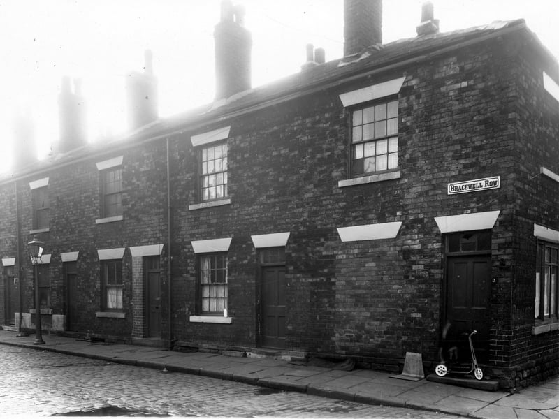 On the left is number 10 Bracewell Row, moving right 2 is at the corner with Lloyd Street. A new child's scooter is on the step of number 2. This block of property went through to Kirkstall Road, where there were shop fronts numbering from 166 - 172. Pictured in December 1959.
