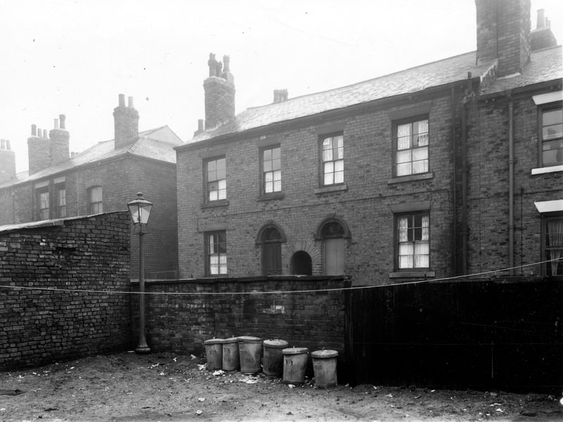 The wall in the centre of this view is between Kings, Greystone and Laptons Buildings area and Back Lloyd Street. Two houses on Back Lloyd Street are in the centre 11 on the left, 10 on the right. Pictured in December 1959.