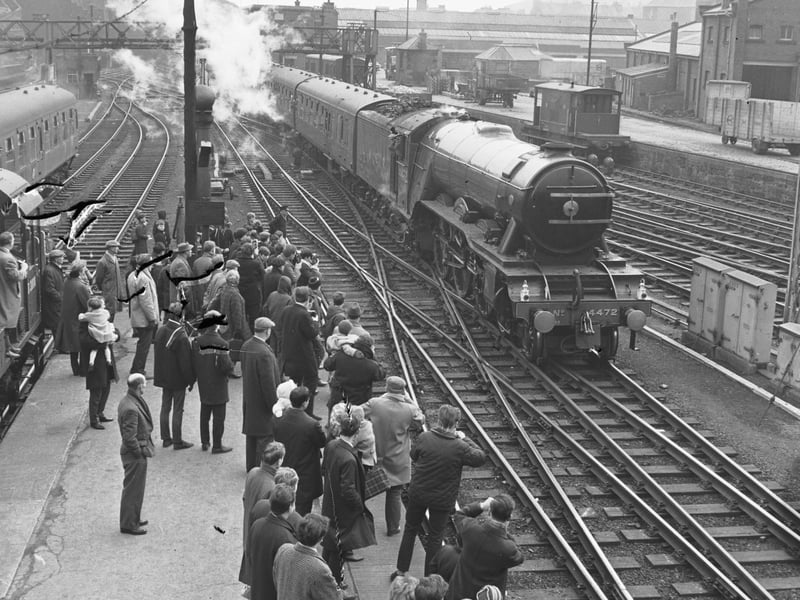 Trainspotters taking photographs of the Flying Scotsman steam engine at Waverley Station in April 1966.
