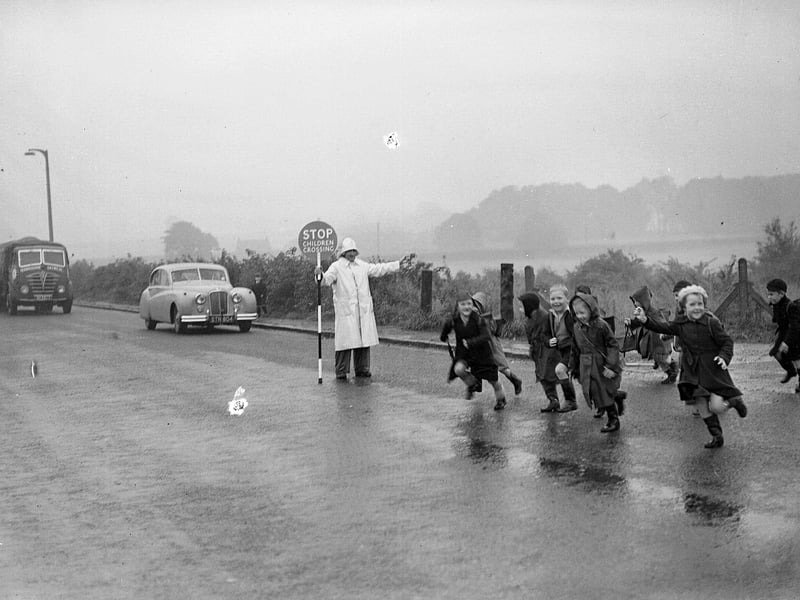 Children crossing street from Dalkeith's Pease Flat Housing Scheme to school in October 1954.