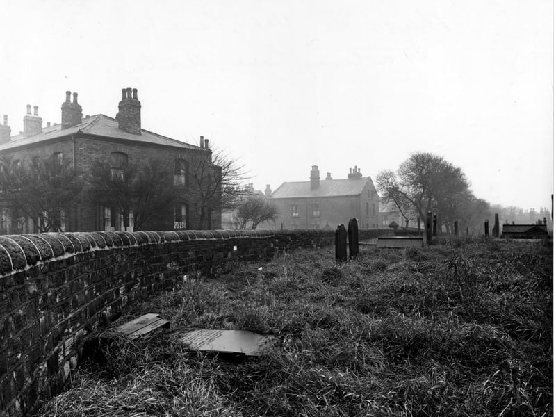 Part of the graveyard of St. Bartholomew's Church on Church Road and Strawberry Lane. Houses are visible in the background. Pictured in December 1947,