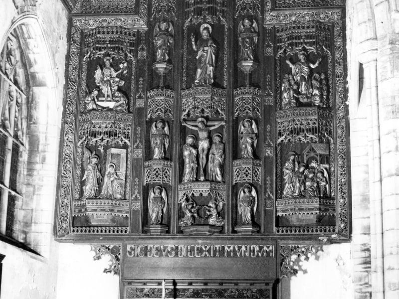Inside St. Edward's Parish Church on Brown Lane in September 1981 showing the fine reredos and rood screen.