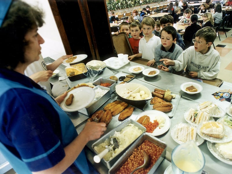 Dinner ladies serve children queuing for lunch at Gracemount Primary School, Edinburgh, in 1996