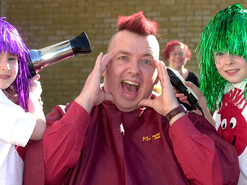 Mia, left, and Norton Whyte got the chance to shave Wicor Primary School headteacher Mark Wildman's head after the school met his challenge to raise over £2000 for Comic Relief in 2003.

