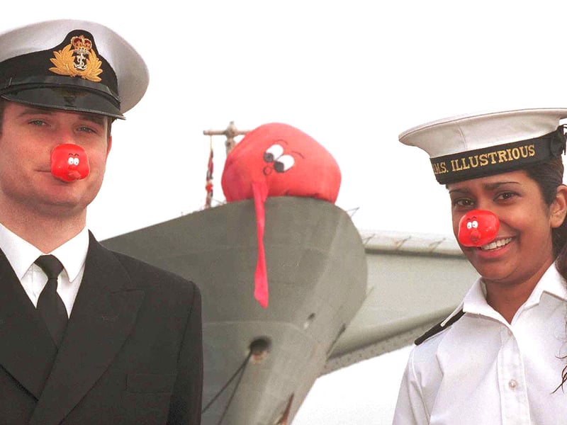 Sub Lieutenant Tony Hopkins, 26, and operator maintainer Nanda Ramtohul, 24, raising cash for Comic Relief on HMS Illustrious in 2005. The young officers transformed the ship's 'killer tomato',  a five-metre wide bright orange target which is used for target practice at sea, mainly for aircraft, into a giant red nose.
 
