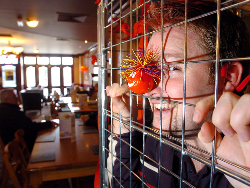Phil Walter, 26, the duty manager of The First Post Pub in Cosham in the cage the pub he's stayed in for 24 hours for Comic Relief in 2005 