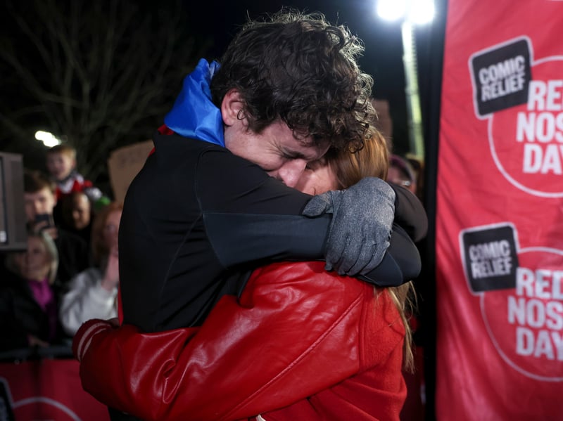 Greg James hugs his wife Bella Mackie after he crosses the finish line in Galashiels on Day 8 of his Longest Ride challenge on Thursday, March 19.