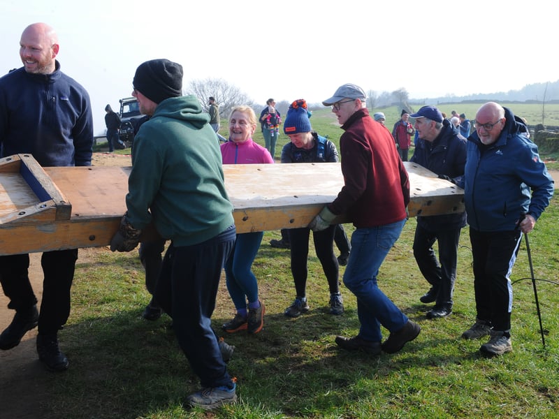The wooden cross is carried in sections up to the Chevin 