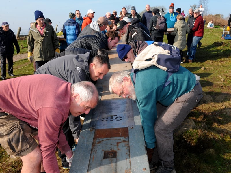 Scores of volunteers help to put the cross into position every year