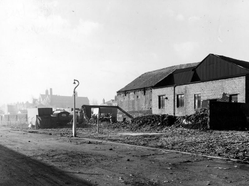 Looking west at the old Oven Works on Primrose Lane in November 1954. A group of lorries and caravans have formed a camp in front.